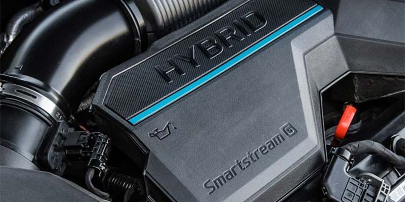 Close-up of a hybrid Smartstream G engine under the hood of a vehicle.