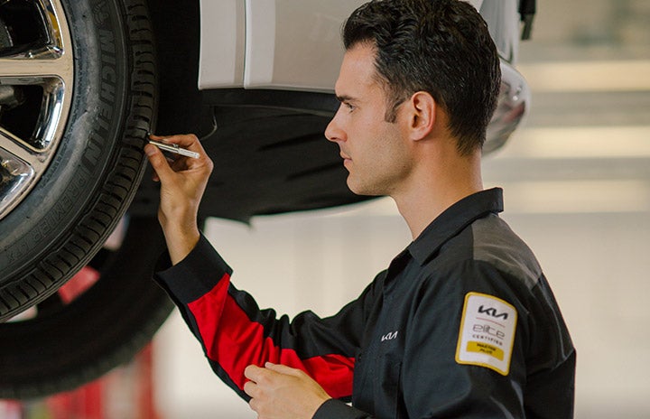 kia service tech checking tires Keffer Kia in Mooresville NC